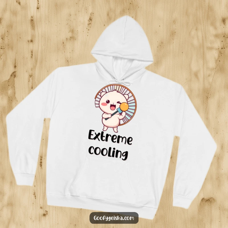 Funny hoodie features a round Kawaii character excitedly holding a giant fan, offering warmth and cool vibes.
