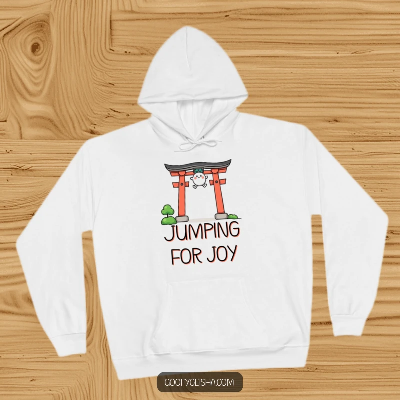 Funny hoodie illustrated with a small, rounded character executing a dynamic jump over an iconic, stylized torii gate.