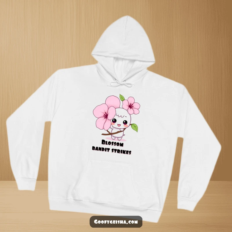 Funny Kawaii hoodie with a mischievous character tapping a large cherry blossom petal, offering cozy comfort and adorable humor.