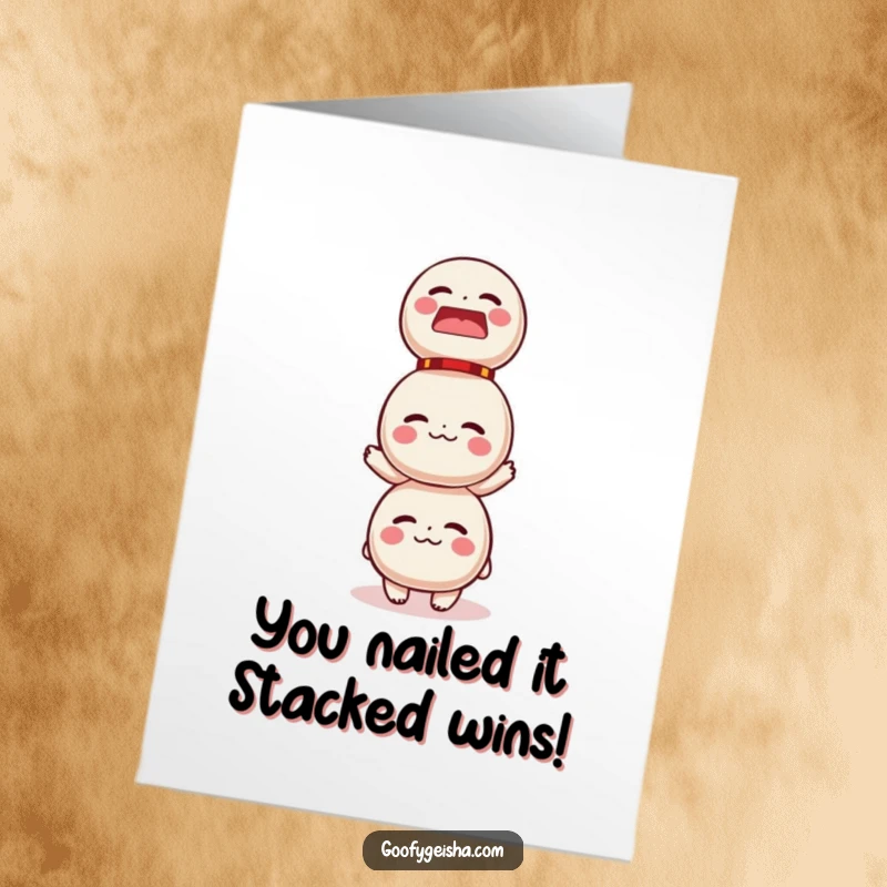 Funny Free Printable Congratulations Card: Character attempting to balance a wobbly tower of Daruma dolls, a comical struggle.